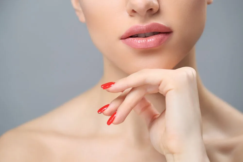 Close-up of a lip filler injection procedure enhancing lip volume.